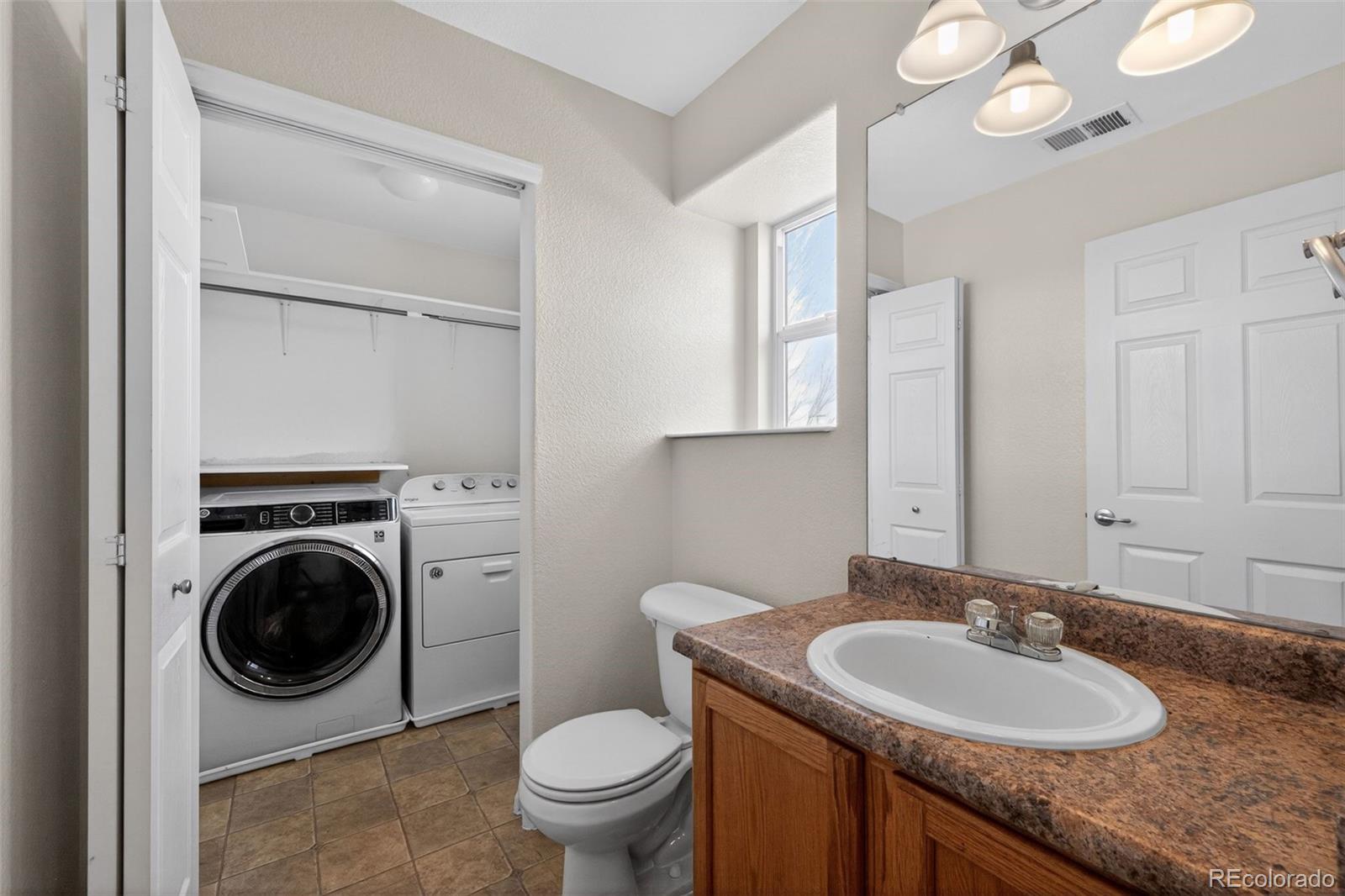 6603 Autumn Ridge Drive, Unit 2 Fort Collins, CO 80525 - Photo 6 of 33 a bathroom with a granite countertop sink and a mirror