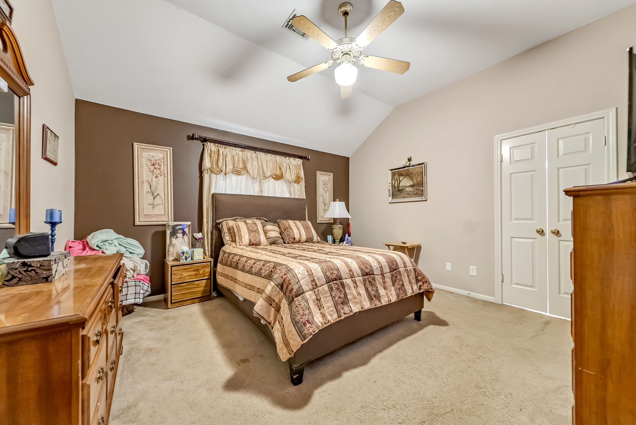 22906 Prairie Bird Lane Spring, TX 77373 - Photo 12 of 14 a spacious bedroom with a bed and a chandelier