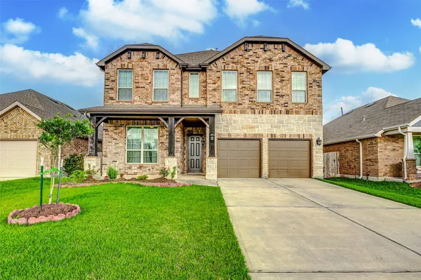 a view of a brick house with a yard