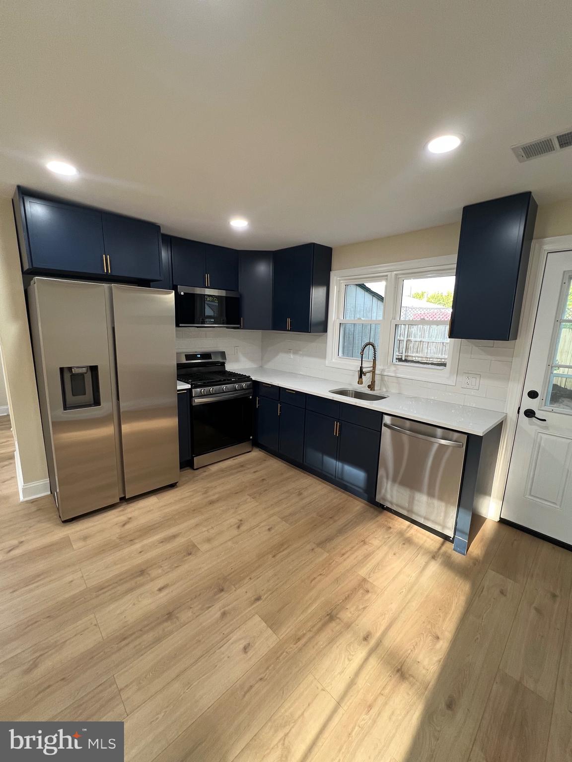810 Quince Lane Secane, PA 19018 - Photo 20 of 44 a kitchen with stainless steel appliances a sink a stove a microwave a sink and a refrigerator