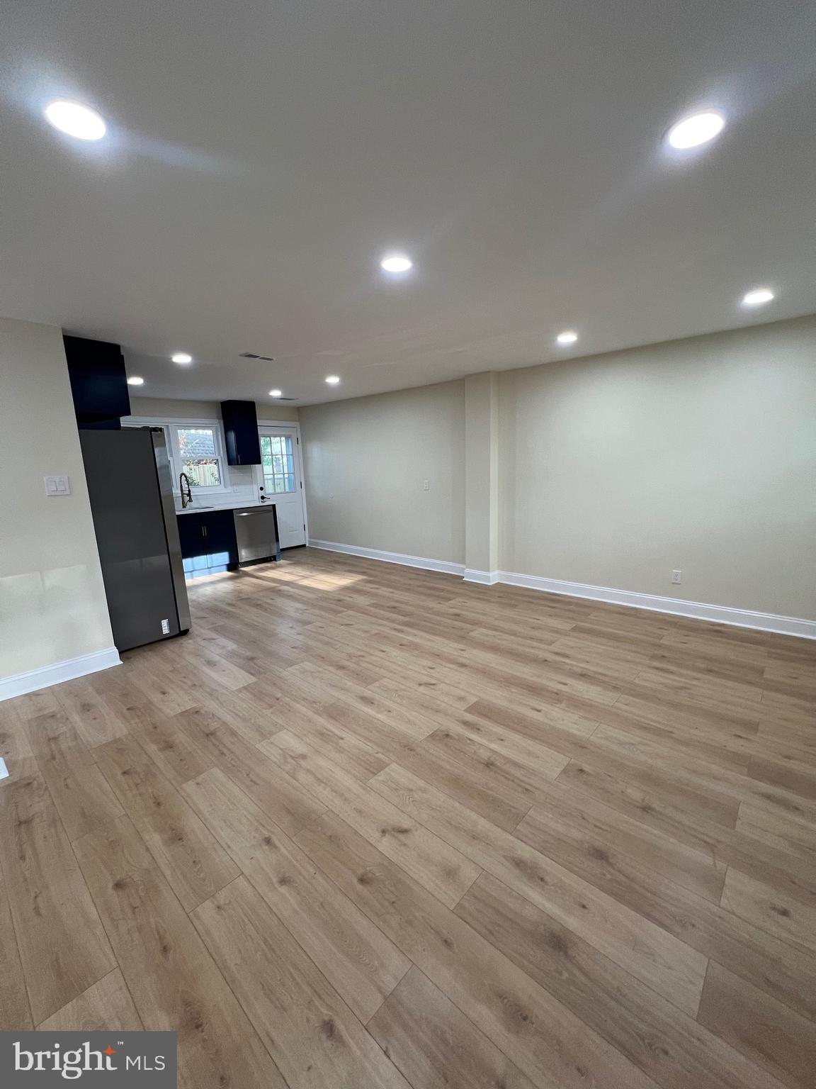 810 Quince Lane Secane, PA 19018 - Photo 23 of 44 an empty room with wooden floor and a fireplace