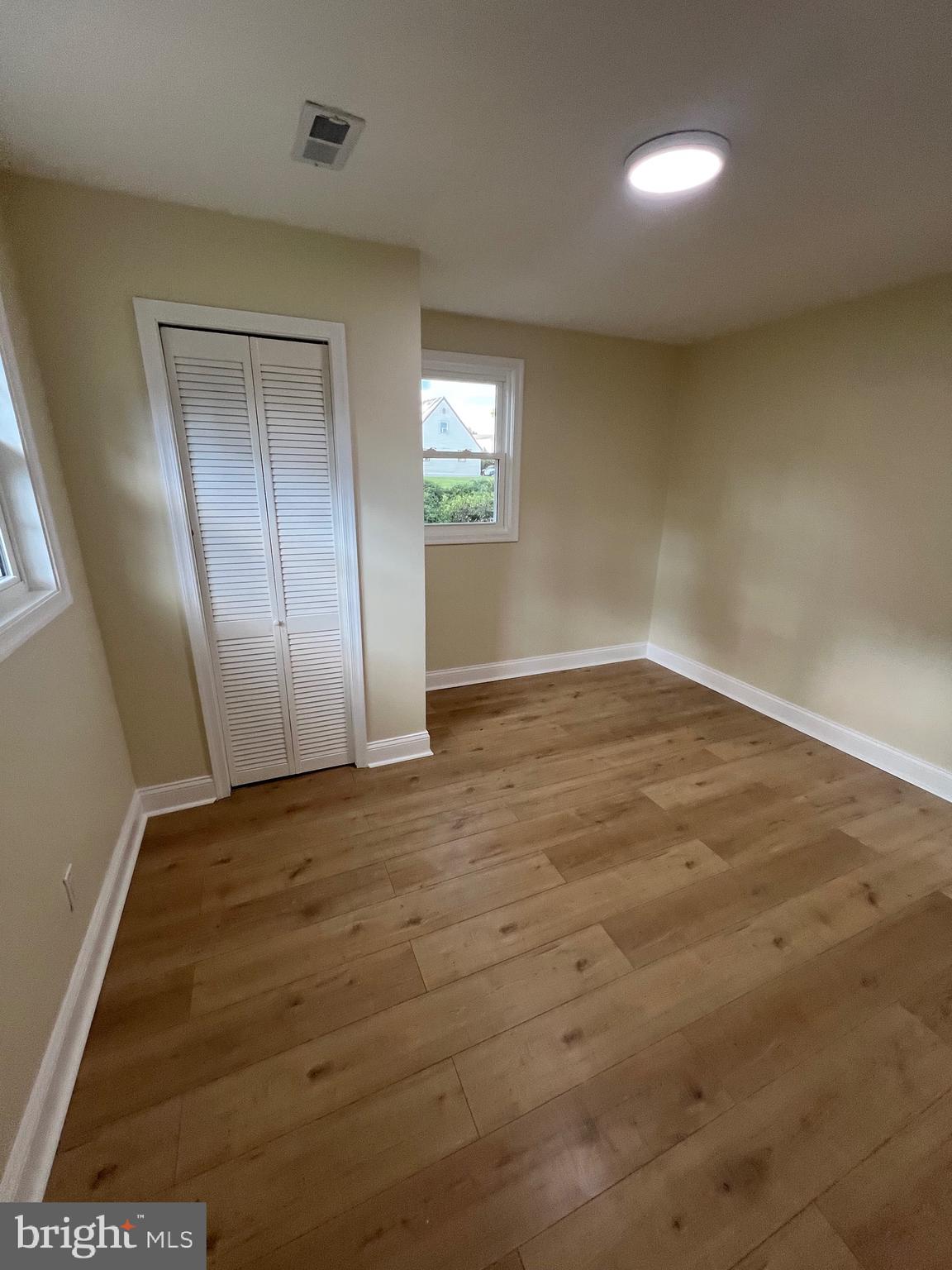 810 Quince Lane Secane, PA 19018 - Photo 32 of 44 an empty room with wooden floor and windows