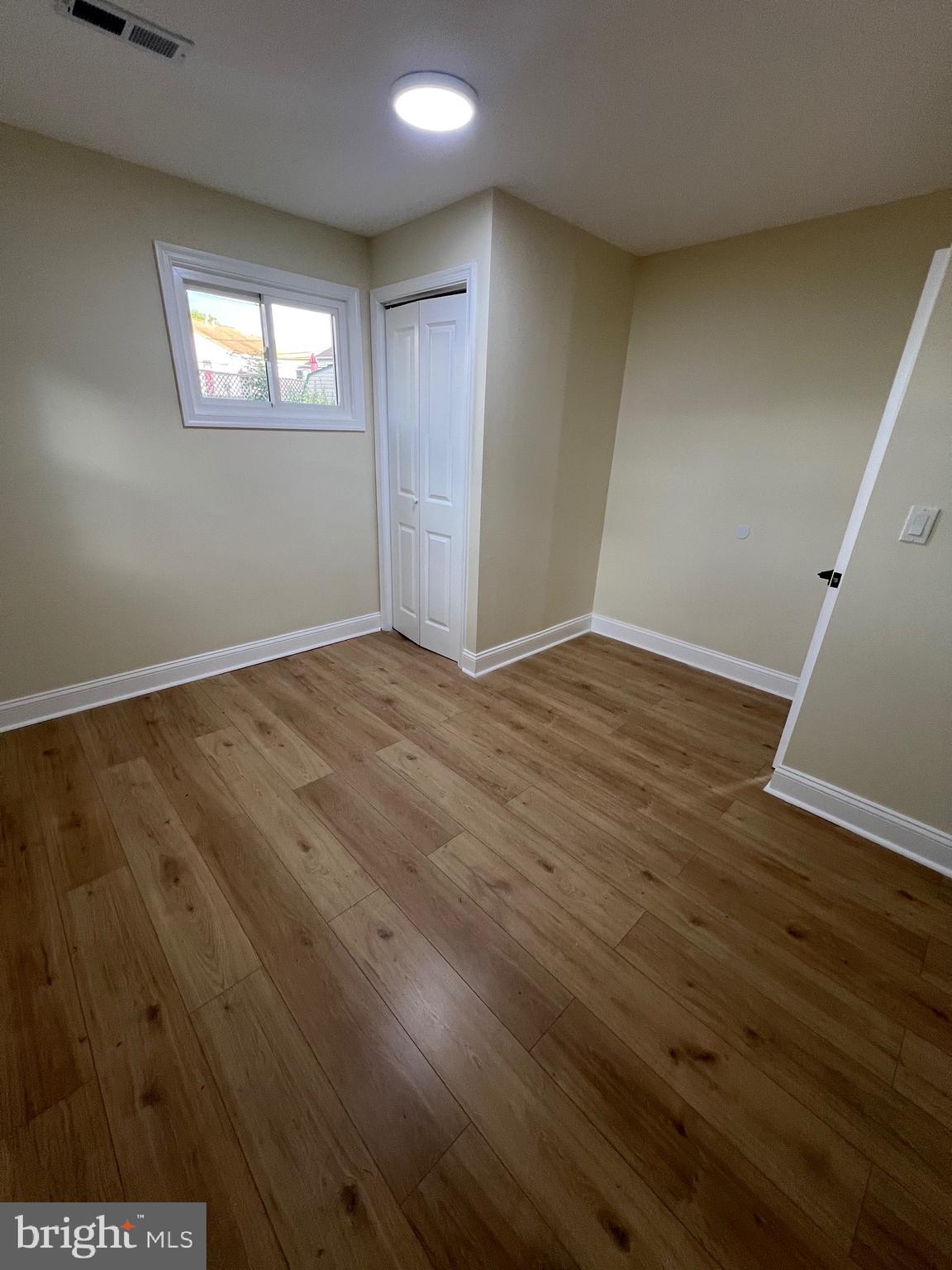 810 Quince Lane Secane, PA 19018 - Photo 36 of 44 an empty room with wooden floor and windows