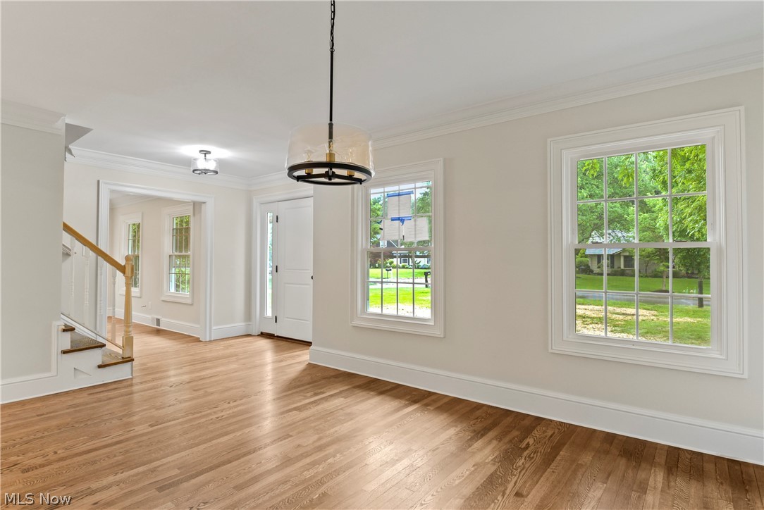 4891 Countryside Road Cleveland, OH 44124 - Photo 22 of 34 Spare room with an inviting chandelier, light hardwood / wood-style flooring, and crown molding