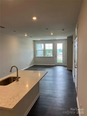 a bathroom with a granite countertop sink a toilet and a mirror