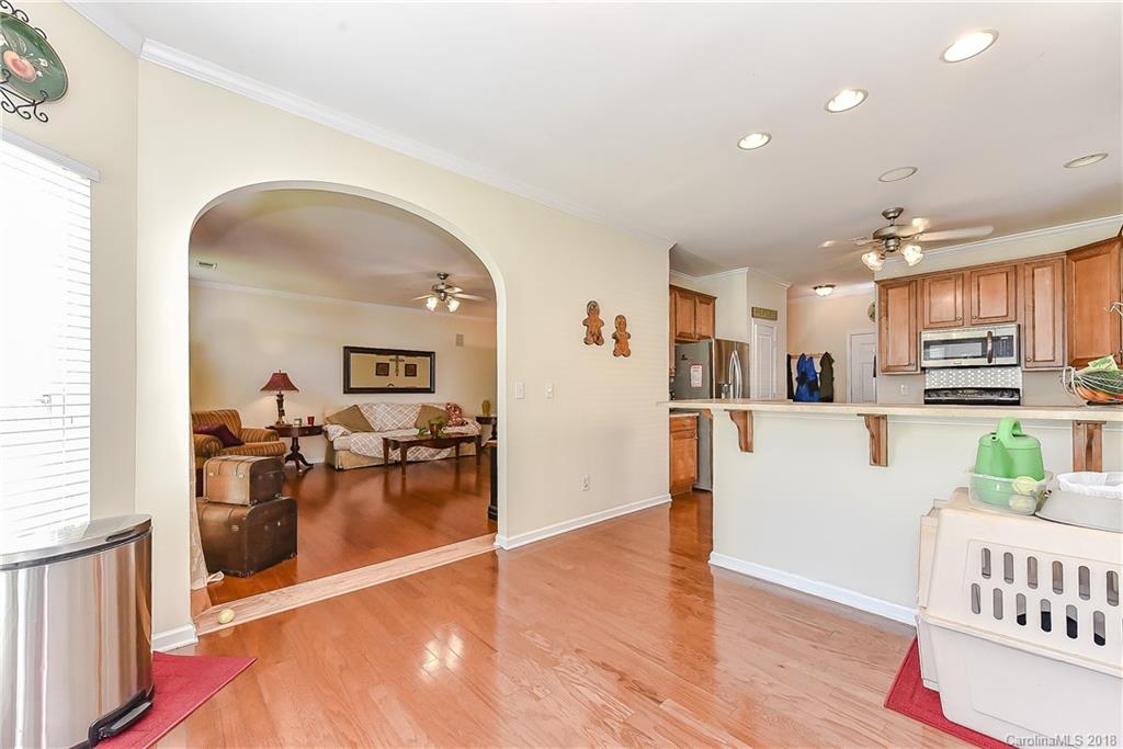 325 Sand Paver Way, Unit 99 Fort Mill, SC 29708 - Photo 17 of 25 a view of a living room and kitchen with a sink wooden floor and windows
