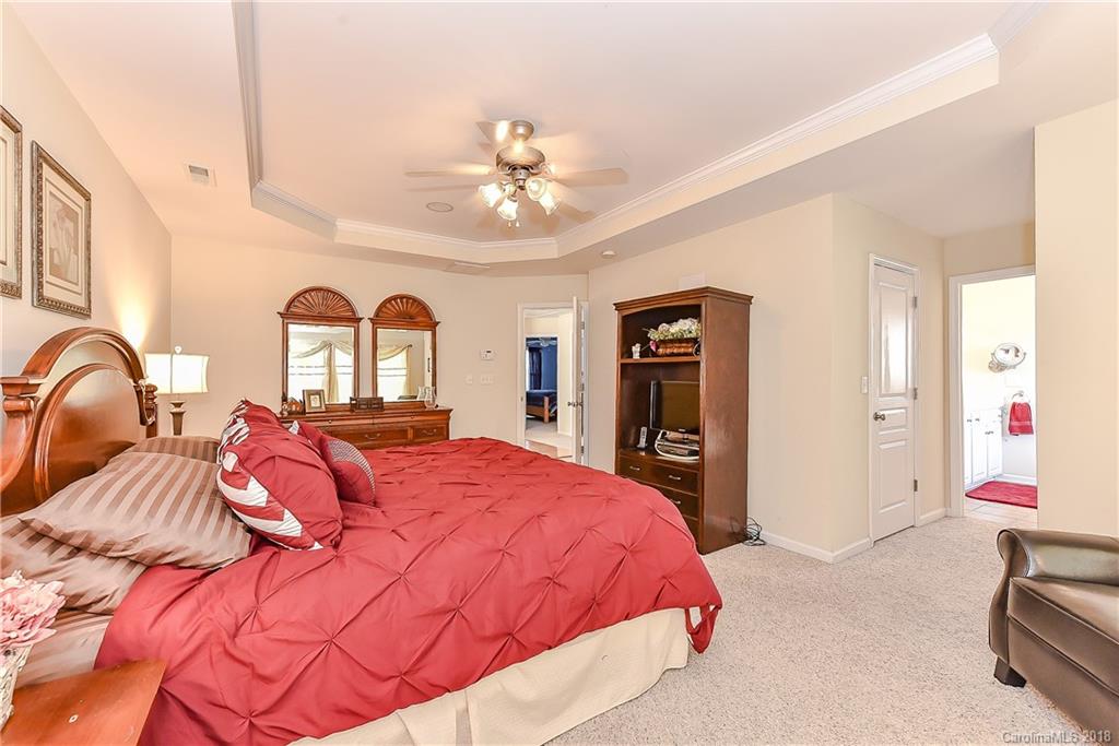 325 Sand Paver Way, Unit 99 Fort Mill, SC 29708 - Photo 19 of 25 a bedroom with a bed and ceiling fan