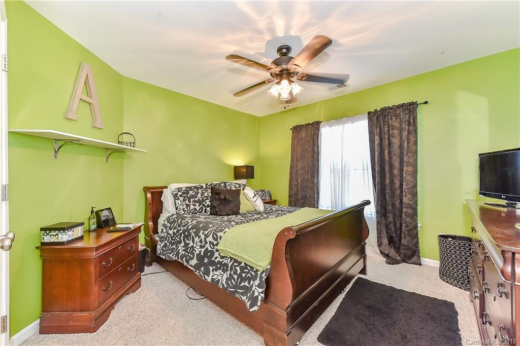 325 Sand Paver Way, Unit 99 Fort Mill, SC 29708 - Photo 20 of 25 a bedroom with a bed and a flat screen tv