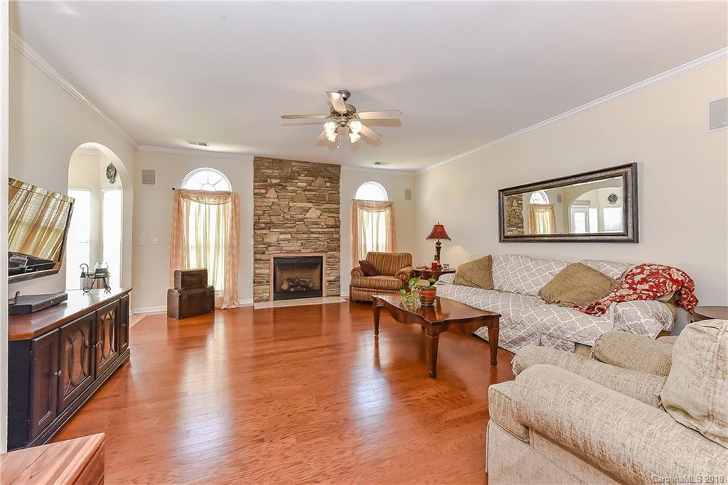 325 Sand Paver Way, Unit 99 Fort Mill, SC 29708 - Photo 7 of 25 a living room with furniture two large window and wooden floor