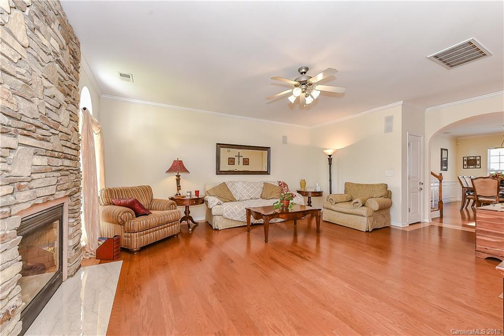 325 Sand Paver Way, Unit 99 Fort Mill, SC 29708 - Photo 8 of 25 a living room with furniture and a fireplace