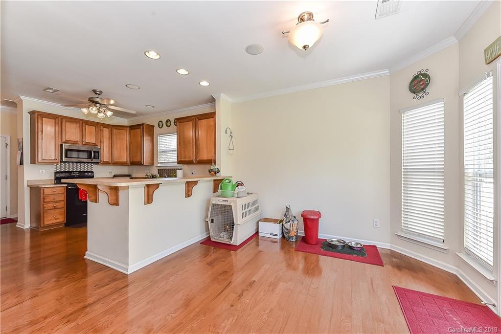 325 Sand Paver Way, Unit 99 Fort Mill, SC 29708 - Photo 10 of 25 a view of kitchen with stainless steel appliances granite countertop a stove and a wooden floors