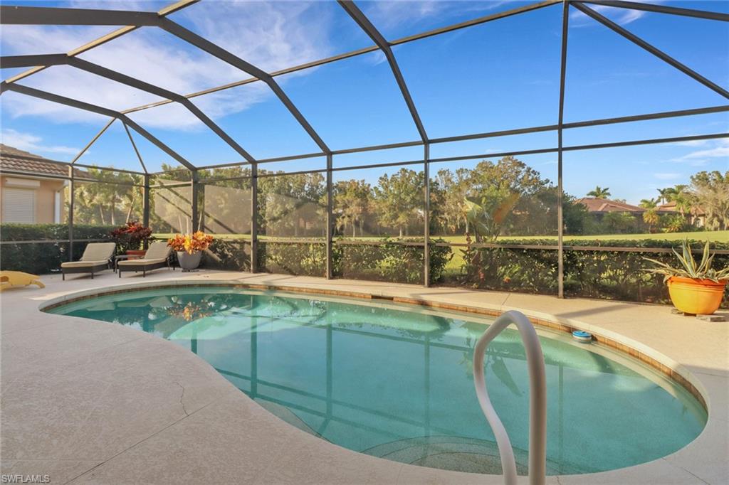 6757 Bent Grass Drive Naples, FL 34113 - Photo 24 of 27 a view of a swimming pool with a patio
