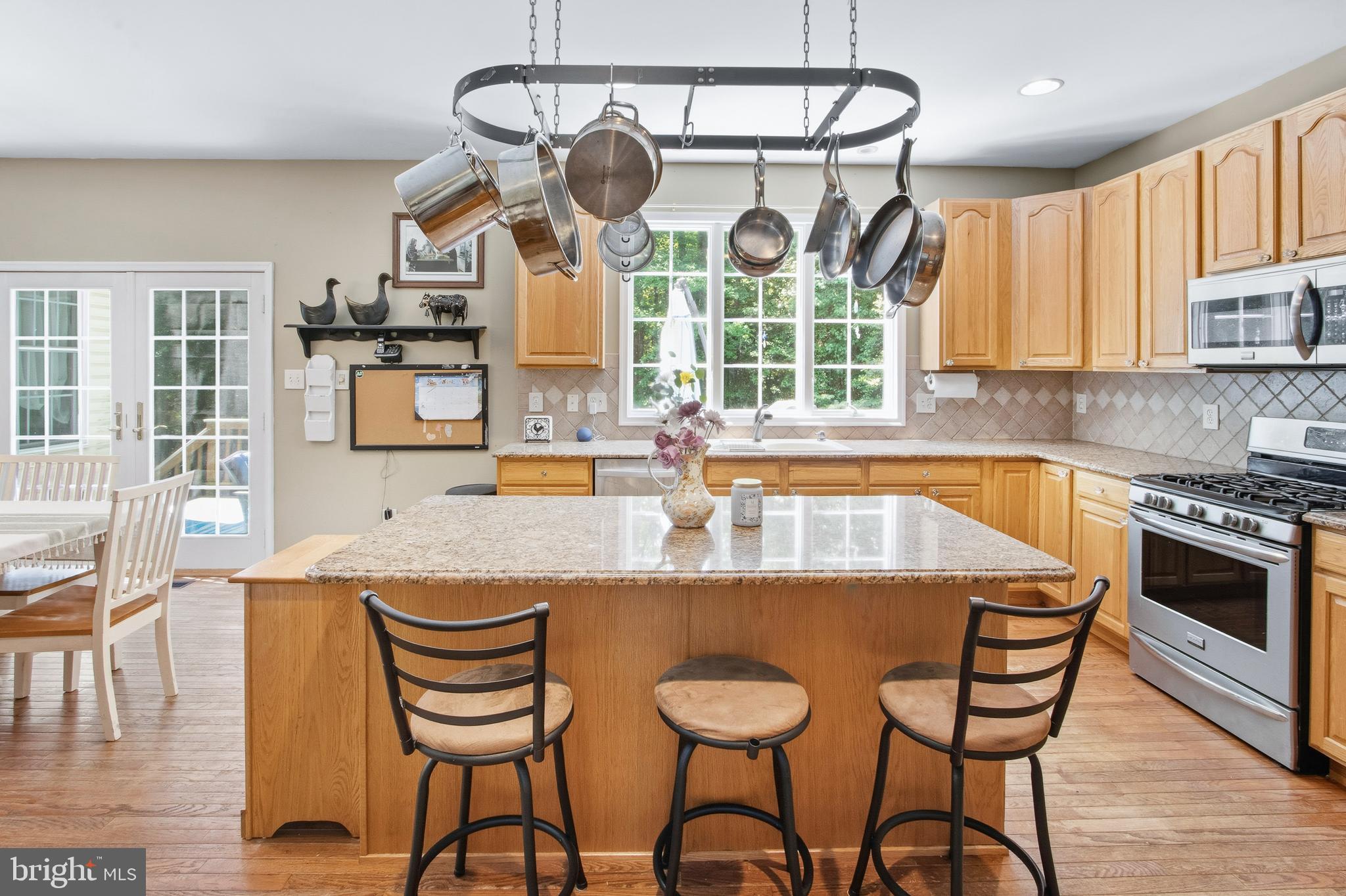 15 Hollybrook Road Mullica Hill, NJ 08062 - Photo 11 of 38 a kitchen with a dining table chairs and stove top oven