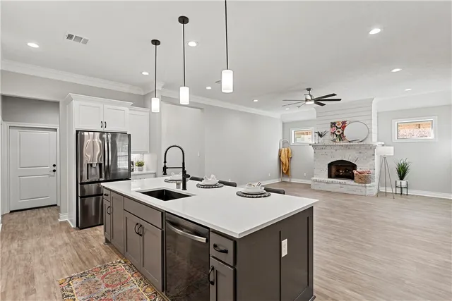 a kitchen with a stove and a white wooden cabinets