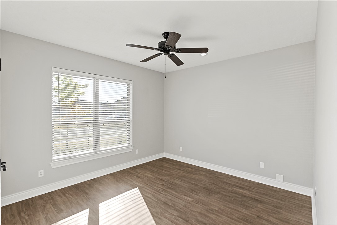 2912 GOLDBERG Drive Bryan, TX 77808 - Photo 19 of 35 an empty room with wooden floor fan and windows