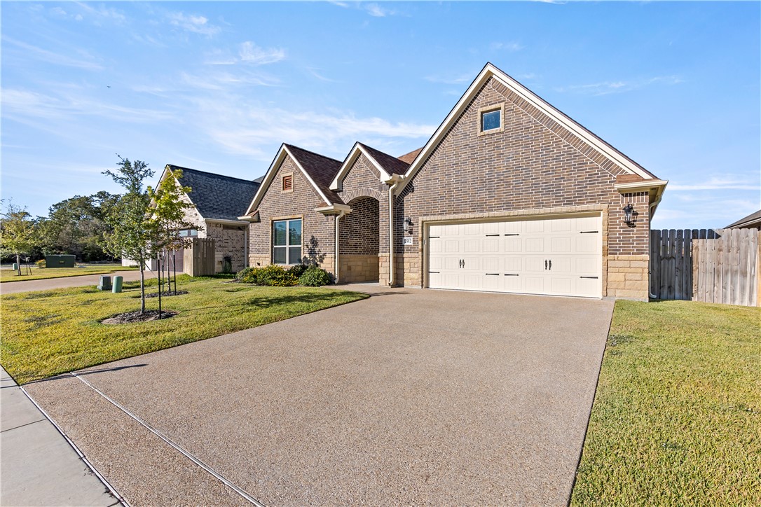 2912 GOLDBERG Drive Bryan, TX 77808 - Photo 2 of 35 a front view of a house with a yard and garage