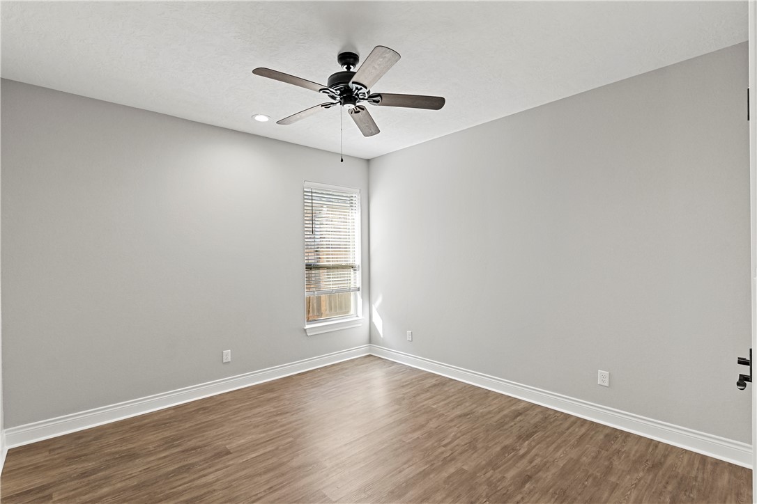 2912 GOLDBERG Drive Bryan, TX 77808 - Photo 21 of 35 a view of an empty room with wooden floor and a window