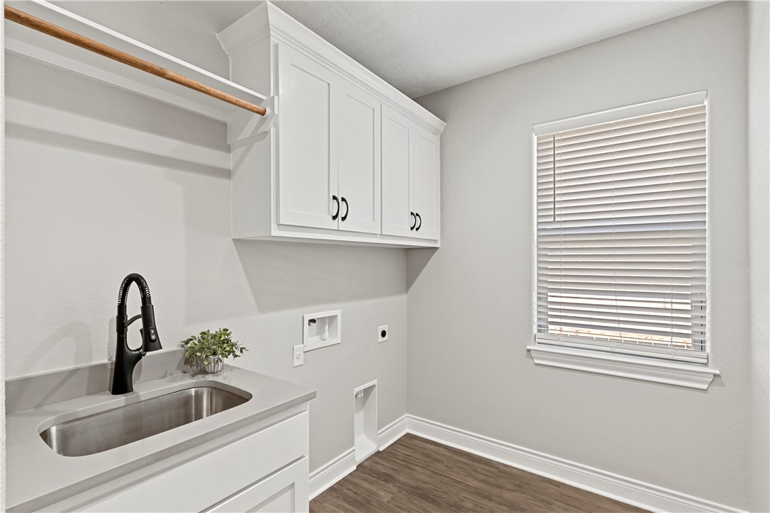 2912 GOLDBERG Drive Bryan, TX 77808 - Photo 22 of 35 a kitchen with a sink and wooden floor
