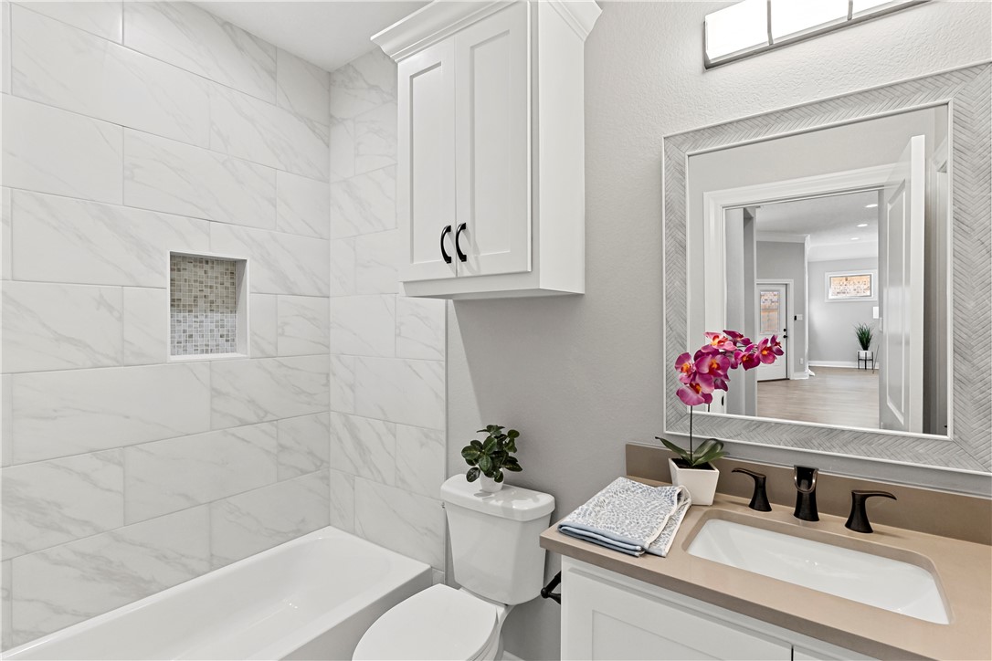 2912 GOLDBERG Drive Bryan, TX 77808 - Photo 25 of 35 a bathroom with a sink vanity mirror and toilet