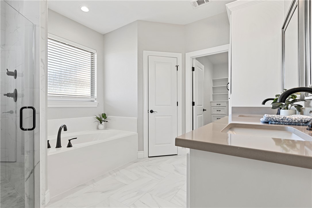 2912 GOLDBERG Drive Bryan, TX 77808 - Photo 28 of 35 a bathroom with a tub sink and mirror