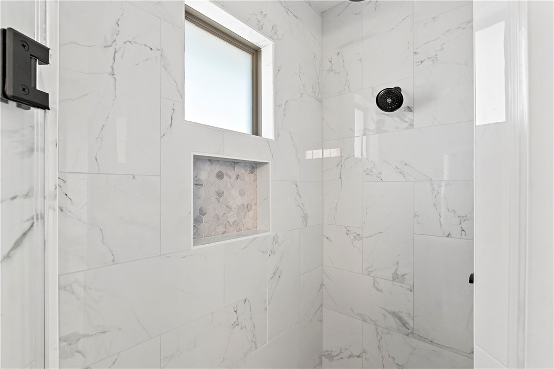 2912 GOLDBERG Drive Bryan, TX 77808 - Photo 30 of 35 a bathroom with a shower and a mirror