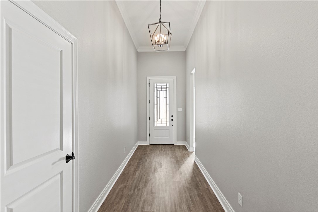 2912 GOLDBERG Drive Bryan, TX 77808 - Photo 4 of 35 a view of a hallway with wooden floor and a window