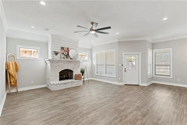 a view of a livingroom with a fireplace and window
