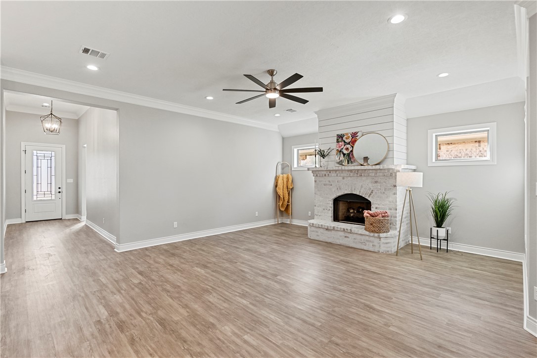 2912 GOLDBERG Drive Bryan, TX 77808 - Photo 8 of 35 a view of a livingroom with a fireplace and a chandelier