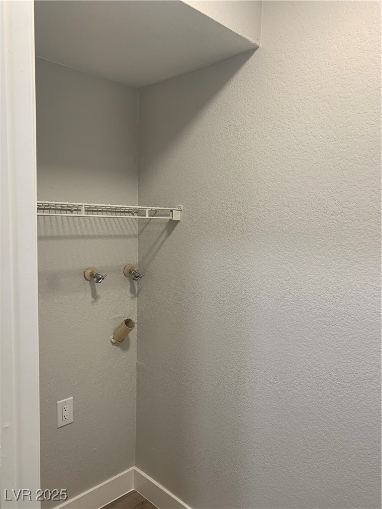 8101 West Flamingo Road, Unit 1102 Las Vegas, NV 89147 - Photo 30 of 54 Laundry area featuring dark wood finished floors and baseboards