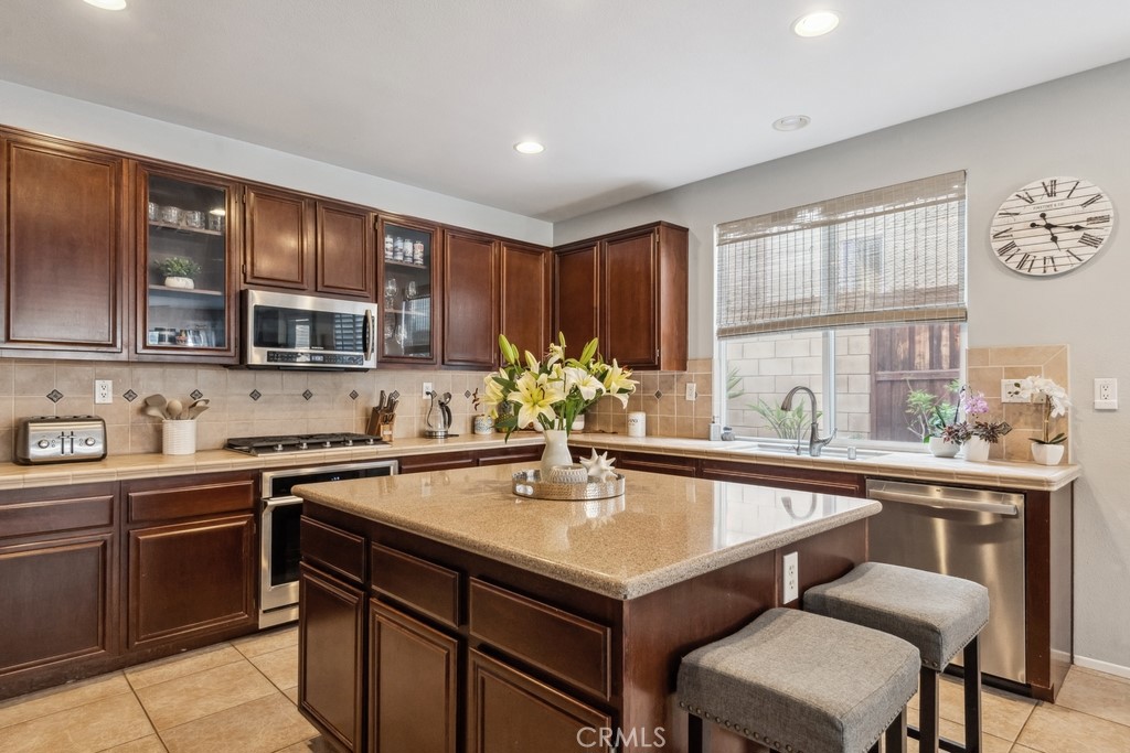 38790 Cobblestone Circle Murrieta, CA 92563 - Photo 13 of 43 a kitchen with a sink cabinets and window
