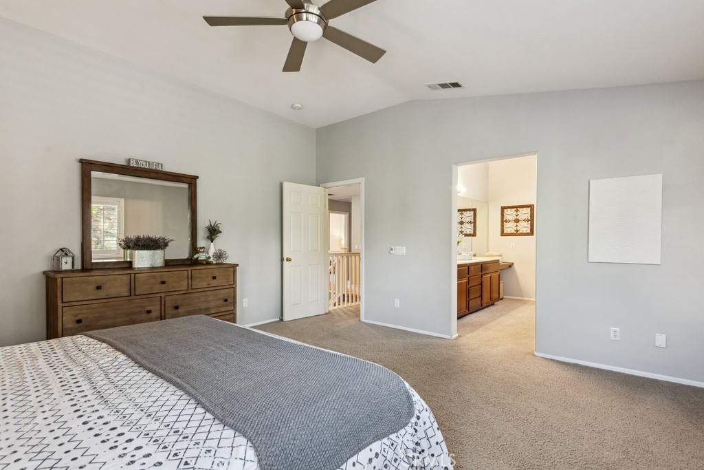 38790 Cobblestone Circle Murrieta, CA 92563 - Photo 23 of 43 a bed room with a bed and a mirror on dresser