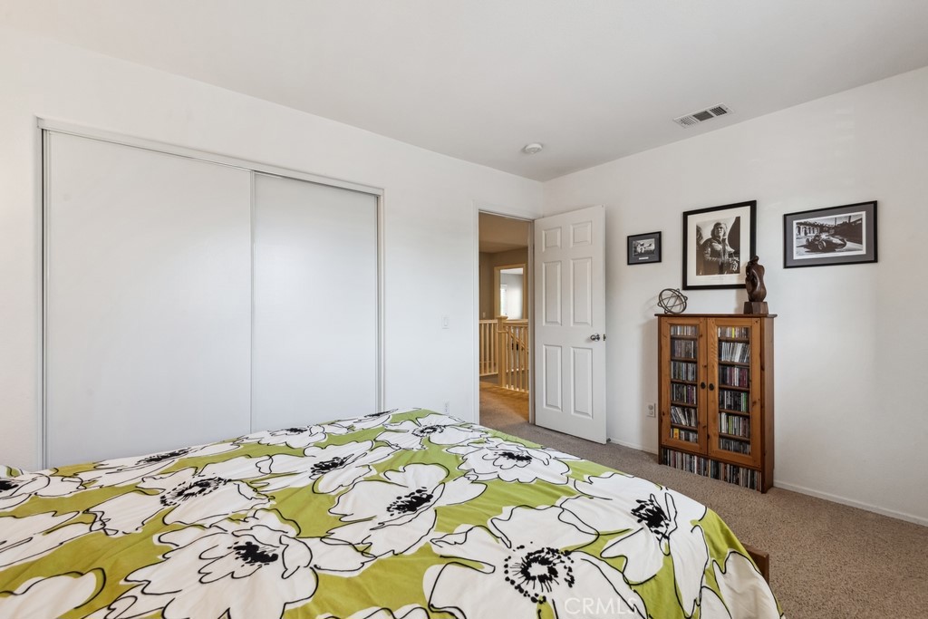 38790 Cobblestone Circle Murrieta, CA 92563 - Photo 27 of 43 a bedroom with bed and cupboard