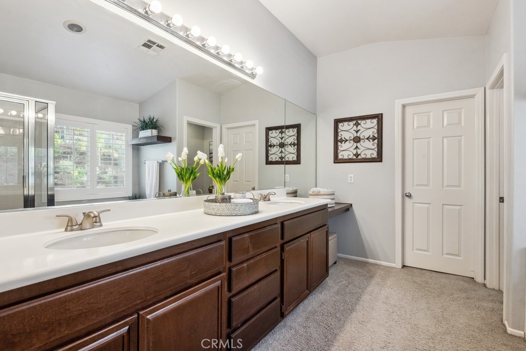 38790 Cobblestone Circle Murrieta, CA 92563 - Photo 29 of 43 a bathroom with a double vanity sink and a mirror