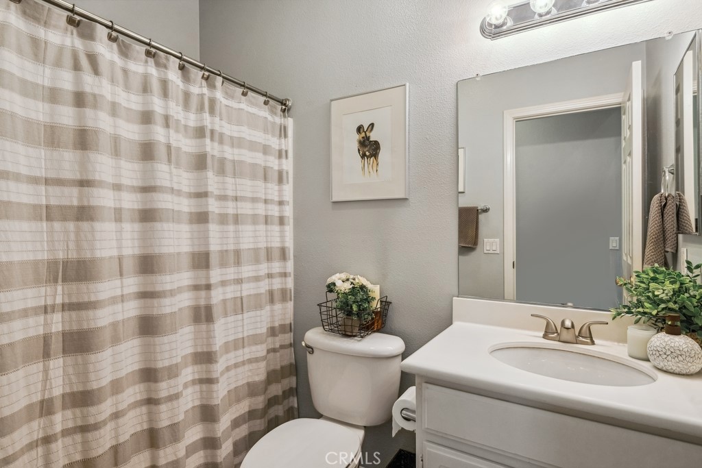 38790 Cobblestone Circle Murrieta, CA 92563 - Photo 32 of 43 a bathroom with a sink toilet and mirror