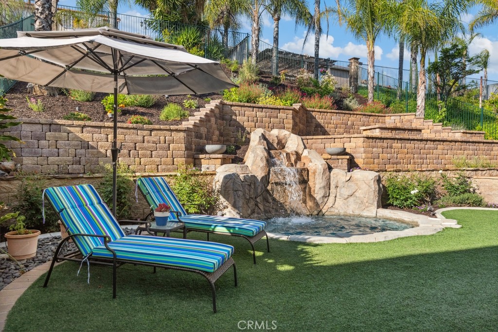 38790 Cobblestone Circle Murrieta, CA 92563 - Photo 34 of 43 a view of a patio with a table chairs and a tub