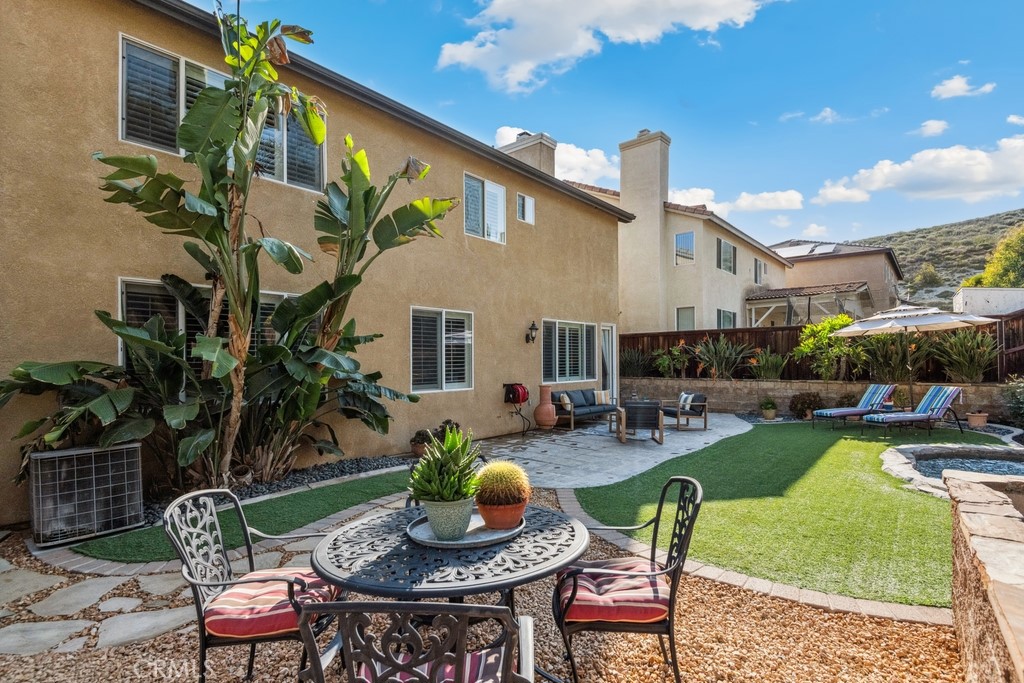 38790 Cobblestone Circle Murrieta, CA 92563 - Photo 39 of 43 a view of a patio with couches table and chairs with potted plants and wooden fence