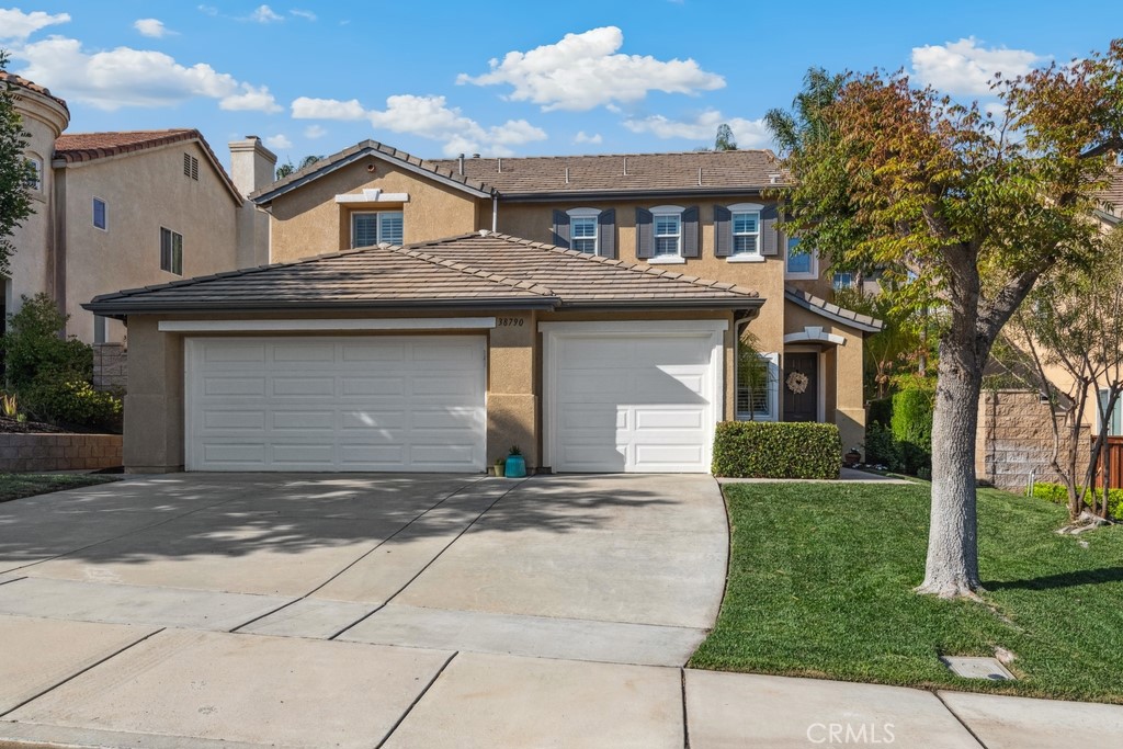 38790 Cobblestone Circle Murrieta, CA 92563 - Photo 5 of 43 a front view of a house with a garden and trees