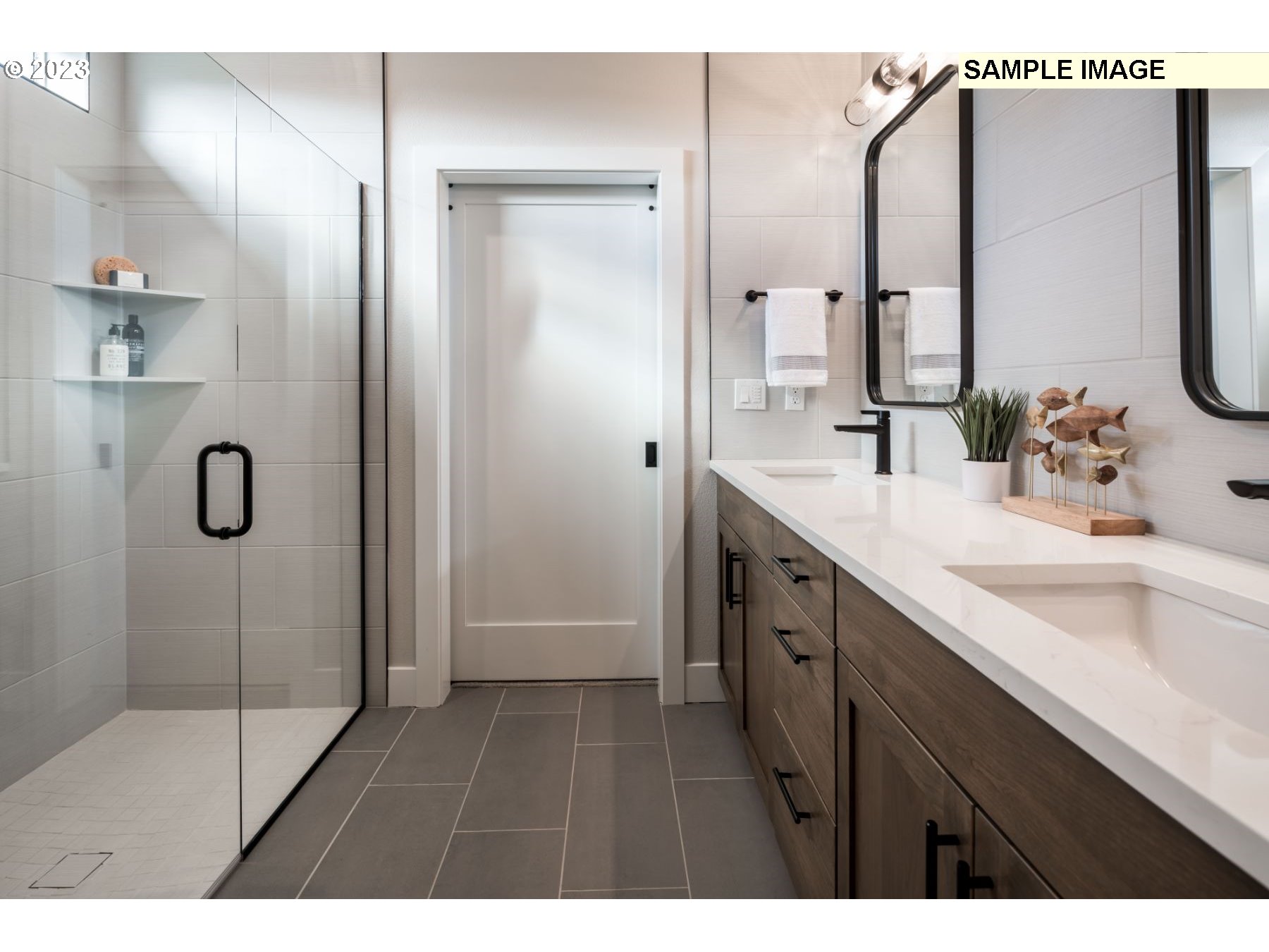 1121 South 46th Place Ridgefield, WA 98642 - Photo 11 of 18 a bathroom with a double vanity sink a mirror and a shower
