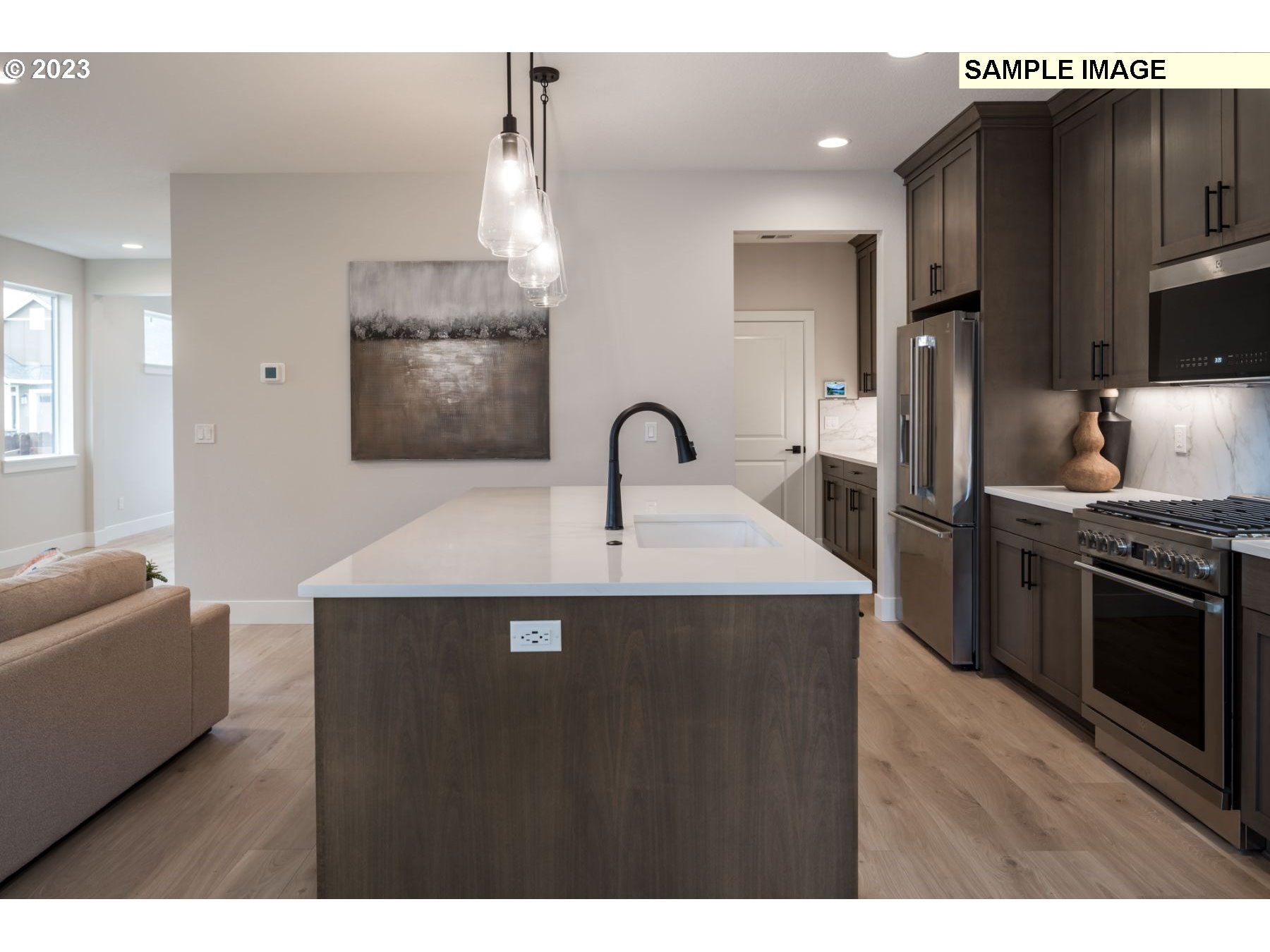 1121 South 46th Place Ridgefield, WA 98642 - Photo 8 of 18 a kitchen with stainless steel appliances a sink stove and refrigerator