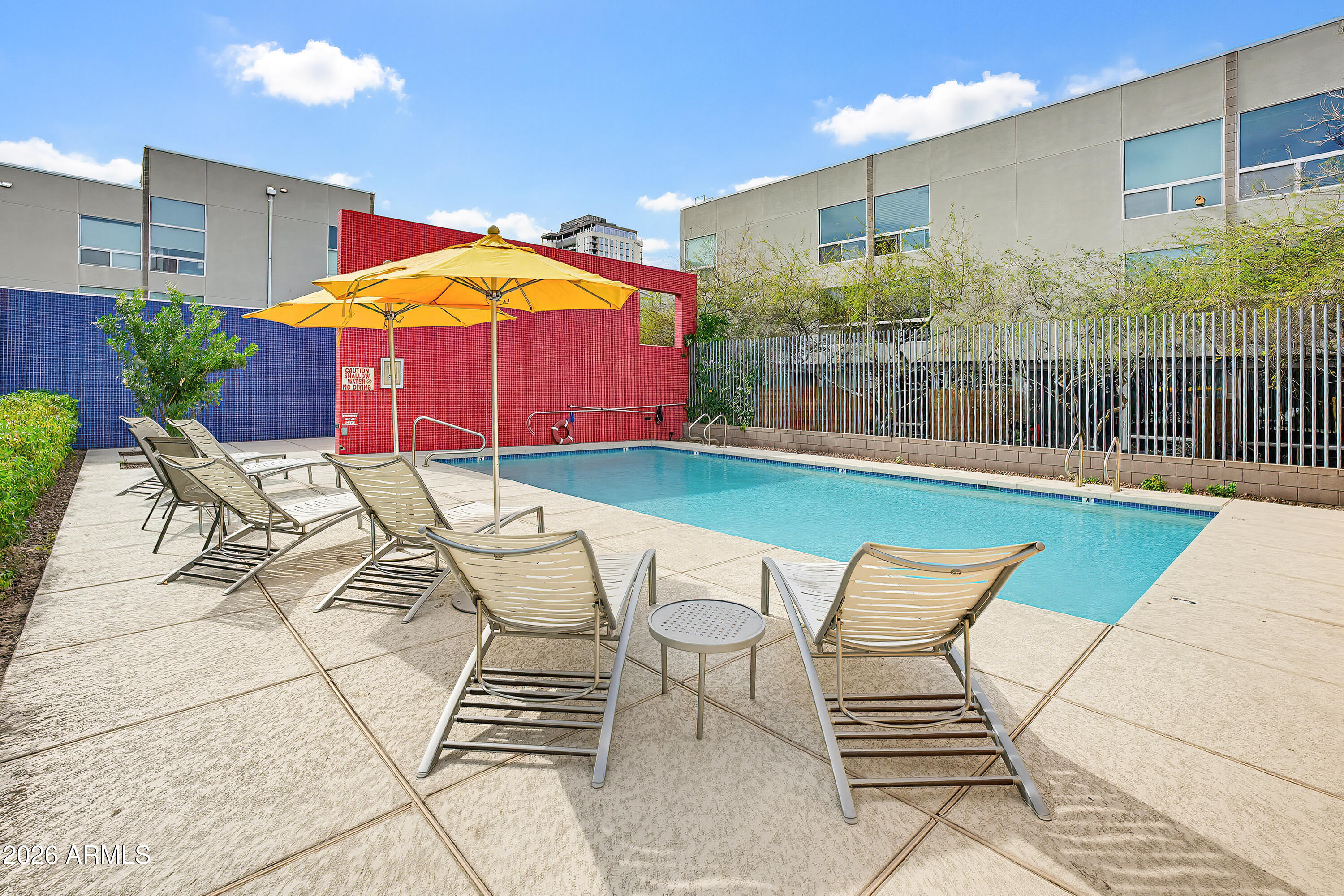 727 East Portland Street, Unit 35 Phoenix, AZ 85006 - Photo 40 of 49 a view of a swimming pool with a lounge chairs