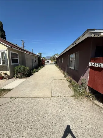 a black car parked in front of a house