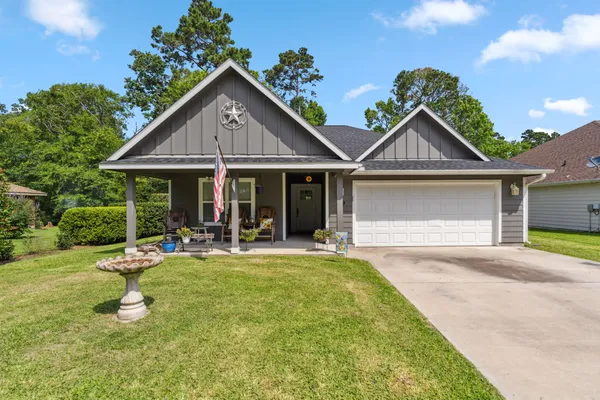 a front view of a house with garden and porch