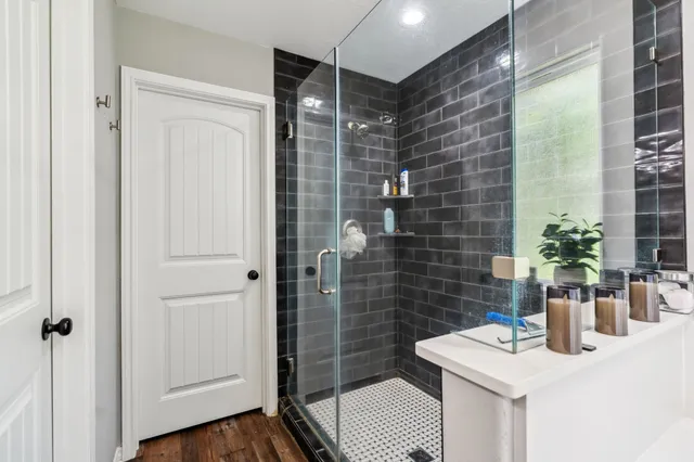 a bathroom with a sink a toilet and shower