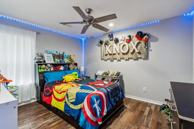 a bedroom with a bed that has a blanket on it and next to a window