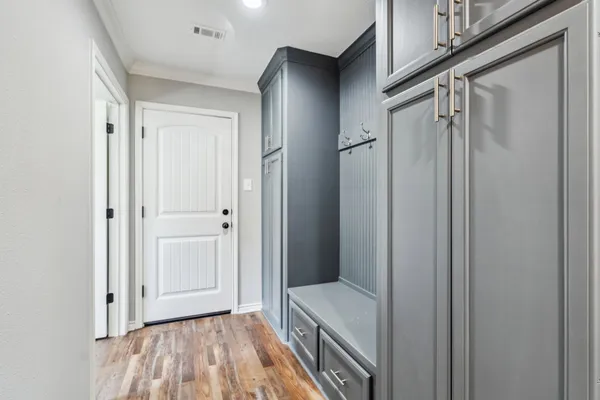 a view of a hallway with wooden floor and a hallway