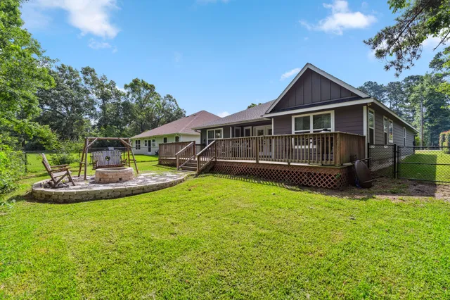 a view of a house with a yard and deck