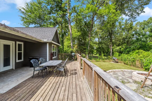 a balcony with wooden floor and outdoor seating