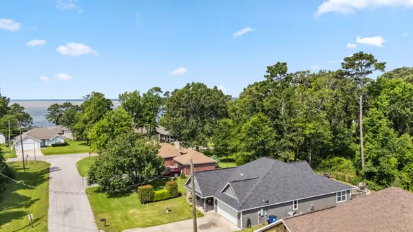 an aerial view of a house with yard swimming pool and outdoor seating