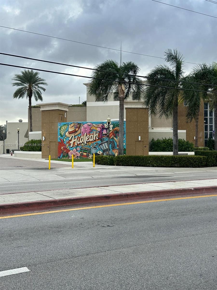 4655 Palm Avenue, Unit 203 Hialeah, FL 33012 - Photo 16 of 16 a front view of a house with a garden and a garage