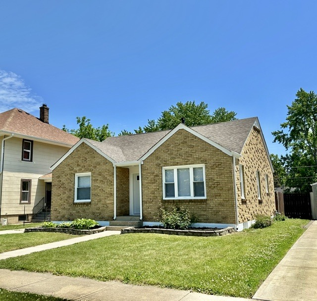 513 Cookane Avenue Elgin, IL 60120 - Photo 2 of 26 a front view of a house with a yard